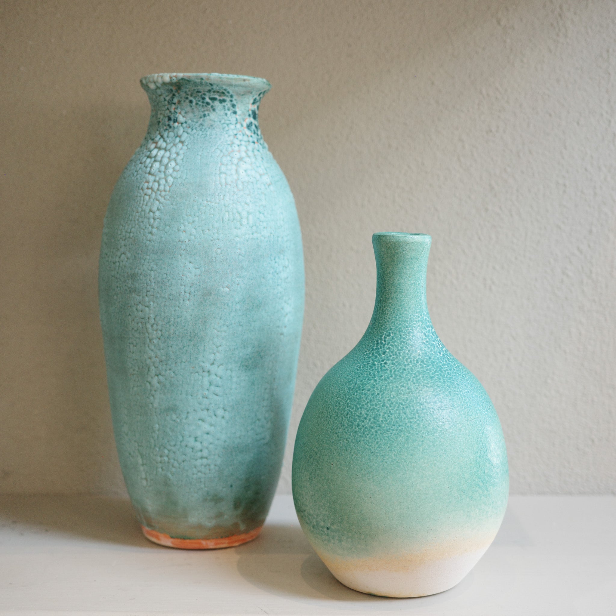 Handmade tall green ceramic vase with small bottle neck vase created by Australian ceramicist Jacqui Sosnowski.