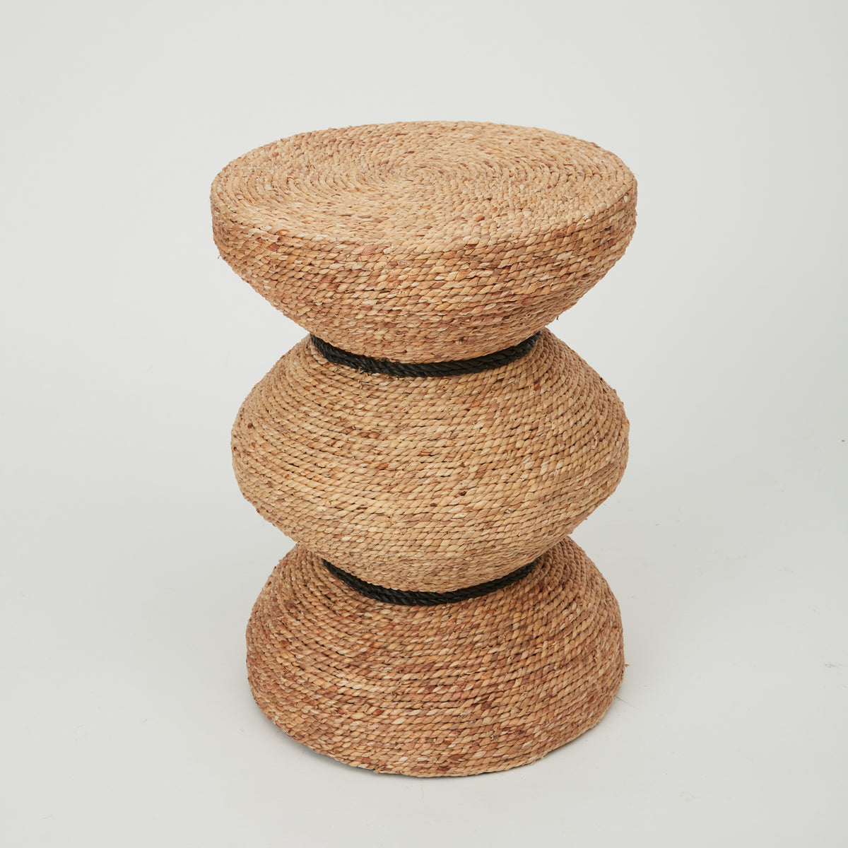 Tiki side table with sculptural hourglass silhouette, handwoven from natural banana leaf rope.